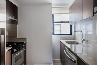 a kitchen with a sink and a stove at Blueground Sutton Place 1bd apartment NYC-1630 in New York
