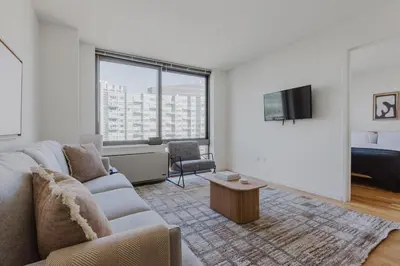 a living room with a couch and a tv at Blueground Long Island City 1bd apartment NYC-1612 in New York