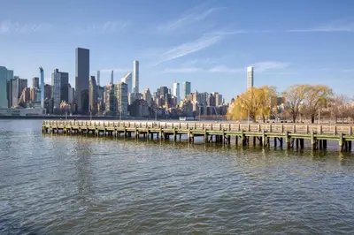 a pier on the water with a city in the background at Blueground Long Island City 1bd apartment NYC-1612 in New York