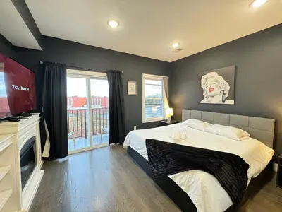 a bedroom with a large bed and a television at Stunning NYC rooftop views minutes away from NYC 2 bedroom 2 bath in Jersey City