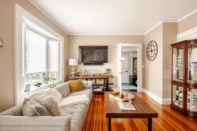 a living room with a couch and a table at Gem by the water with firepit & all fenced backyard 2 Bedrooms in Stamford