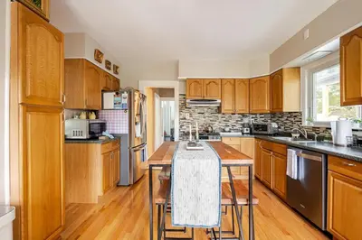a kitchen with wooden cabinets and a wooden counter top at Gem by the water with firepit & all fenced backyard 2 Bedrooms in Stamford