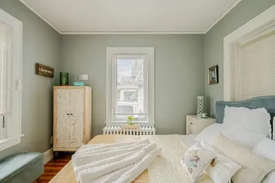a bedroom with a bed with towels on it at Gem by the water with firepit & all fenced backyard 2 Bedrooms in Stamford