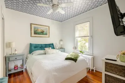 a bedroom with a bed and a ceiling fan at Gem by the water with firepit & all fenced backyard 2 Bedrooms in Stamford