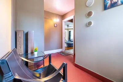 a dining room with a glass table and chairs at Charming Chicopee Getaway in Chicopee