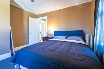 a bedroom with a large blue bed in a room at Charming Chicopee Getaway in Chicopee