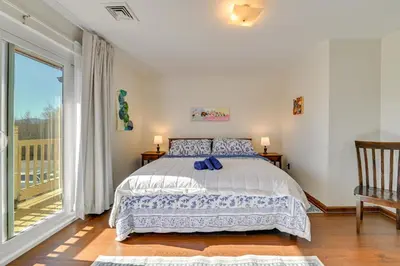 a bedroom with a bed and a large window at Quiet Catskill Getaway with Fire Pit - Near Hiking! in Catskill