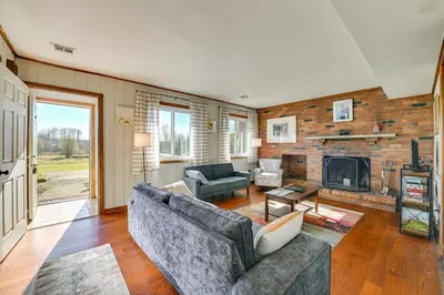 a living room with a couch and a fireplace at Quiet Catskill Getaway with Fire Pit - Near Hiking! in Catskill