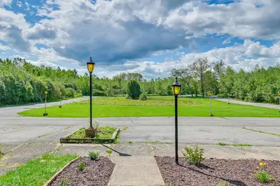 two street lights in the middle of a parking lot at Quiet Catskill Getaway with Fire Pit - Near Hiking! in Catskill