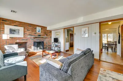 a living room with two couches and a brick wall at Quiet Catskill Getaway with Fire Pit - Near Hiking! in Catskill
