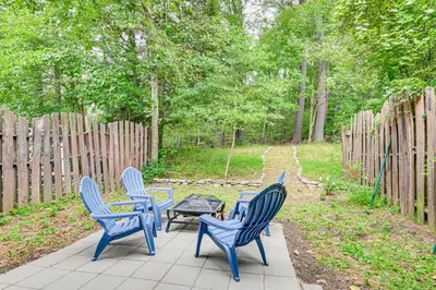 four blue chairs and a table on a patio at Quiet Catskill Getaway with Fire Pit - Near Hiking! in Catskill