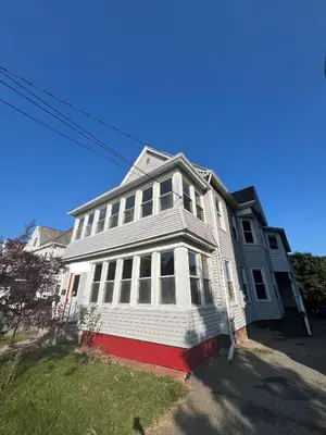a white house with white windows on a street at Holyoke House Oasis - Calm Trips in Holyoke