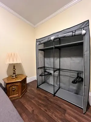 a bedroom with a bunk bed with a lamp and a table at Holyoke House Oasis - Calm Trips in Holyoke