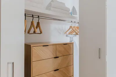 a closet with a wooden cabinet and towels at Blueground Upper East Side studio apartment NYC-1553 in New York