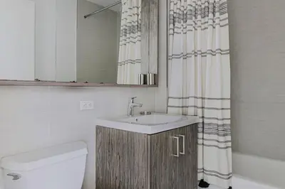 a bathroom with a sink and a shower curtain at Blueground Upper East Side studio apartment NYC-1553 in New York