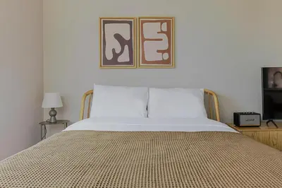 a bedroom with a bed with a picture above it at Blueground Upper East Side studio apartment NYC-1553 in New York