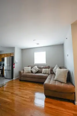 a living room with two couches and a kitchen at Newark Liberty Brick House - Private Bedroom 1 in Newark