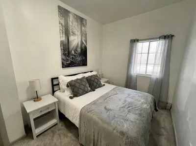 a white bedroom with a bed and a window at Affordable Stay Near Proctors A2 in Schenectady