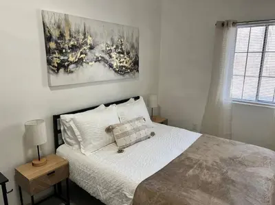 a bedroom with a bed and a painting on the wall at Affordable Stay Near Proctors A2 in Schenectady