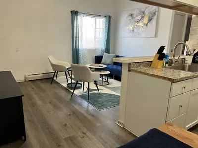 a kitchen and living room with a table and chairs at Affordable Stay Near Proctors A2 in Schenectady