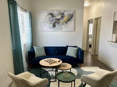 a living room with a blue couch and chairs at Affordable Stay Near Proctors A2 in Schenectady