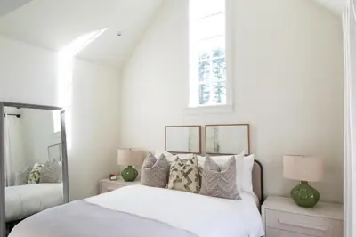 a bedroom with a bed with pillows and a window at Mt Williams Retreat in Williamstown