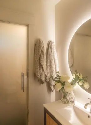 a bathroom with a sink and a vase of flowers at Mt Williams Retreat in Williamstown