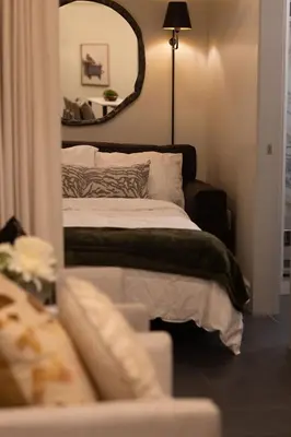 a bedroom with a bed with a large mirror at Mt Williams Retreat in Williamstown
