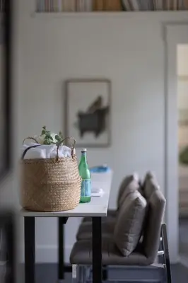 a table with a basket and a bottle on it at Mt Williams Retreat in Williamstown