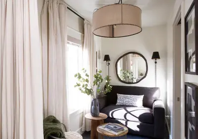 a living room with a couch and a mirror at Mt Williams Retreat in Williamstown