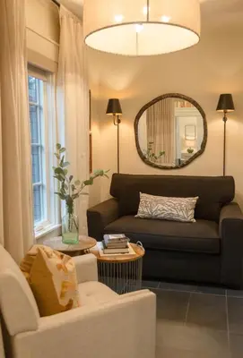 a living room with a couch and a mirror at Mt Williams Retreat in Williamstown
