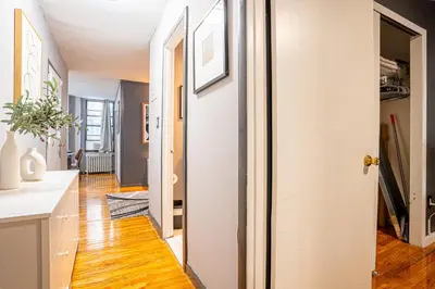 a hallway with a white door and wooden floors at Stylish 3Bd in Manhattan near the Empire State Building in New York