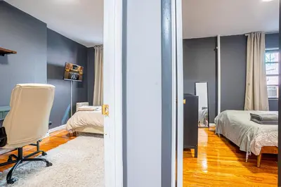 a bedroom with a bed and a desk and a chair at Stylish 3Bd in Manhattan near the Empire State Building in New York