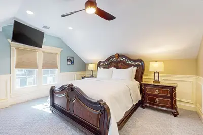 a bedroom with a large bed and a flat screen tv at Near Medical Center! Remote-Work Hub in Holyoke in Holyoke