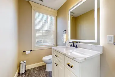 a bathroom with a sink and a toilet and a mirror at Near Medical Center! Remote-Work Hub in Holyoke in Holyoke