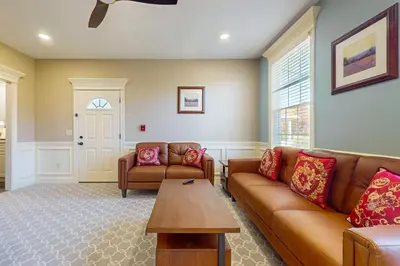 a living room with two couches and a table at Work, Play and Stay! Apt Near Holyoke Medical Center in Holyoke