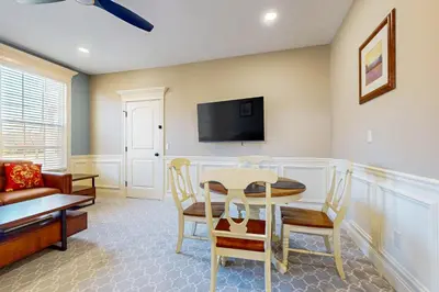 a living room with a table and chairs and a tv at Work, Play and Stay! Apt Near Holyoke Medical Center in Holyoke