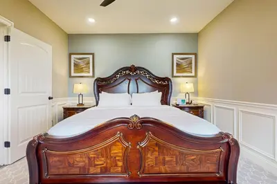 a bedroom with a large wooden bed with white sheets at Work, Play and Stay! Apt Near Holyoke Medical Center in Holyoke