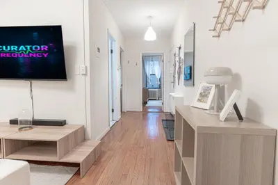 a living room with a flat screen tv on a wall at Charming 3Bd in Manhattan in New York