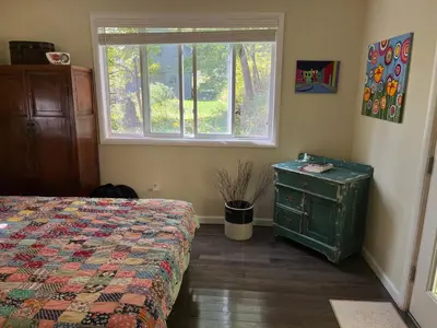 a bedroom with a bed and a window at Victorian Farmhouse in The Catskills in East Meredith