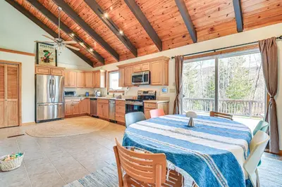 a kitchen and dining room with a table in a room at Mtn-View Home with Deck on 4 Acres in Windham in Windham