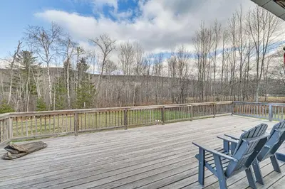 two blue chairs sitting on a wooden deck at Mtn-View Home with Deck on 4 Acres in Windham in Windham