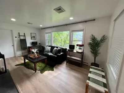 a living room with a couch and a table at Brown House, Lake, Boat Dock, King Bed, Grill in New Fairfield