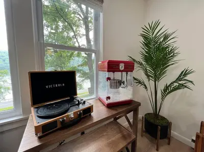 a coffee machine sitting on a table next to a plant at Brown House, Lake, Boat Dock, King Bed, Grill in New Fairfield
