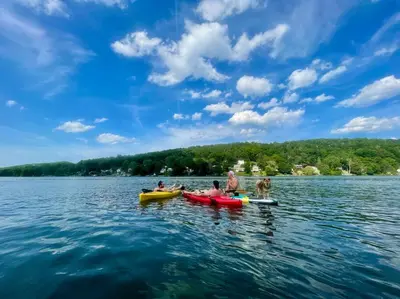 a group of people in kayaks on a lake at Brown House, Lake, Boat Dock, King Bed, Grill in New Fairfield