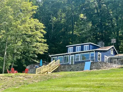 a blue house sitting on top of a hill at Blue House, King Bed, Grill, Pool Table, Air Hockey, Ping Pong in New Fairfield