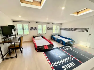 a bedroom with a bed and a car rug at Blue House, King Bed, Grill, Pool Table, Air Hockey, Ping Pong in New Fairfield