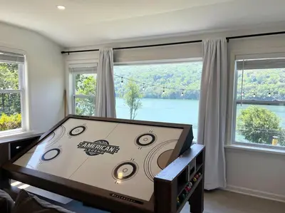 a room with a table with a large window at Blue House, King Bed, Grill, Pool Table, Air Hockey, Ping Pong in New Fairfield