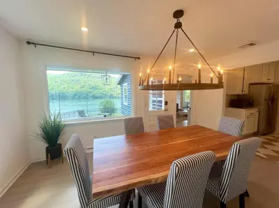 a kitchen and dining room with a wooden table and chairs at Blue House, King Bed, Grill, Pool Table, Air Hockey, Ping Pong in New Fairfield