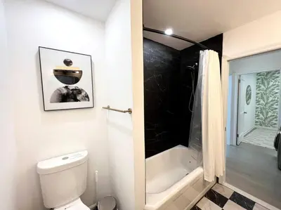 a bathroom with a toilet and a shower and a tub at Blue House, King Bed, Grill, Pool Table, Air Hockey, Ping Pong in New Fairfield